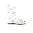 Silver strappy sandals on a white background