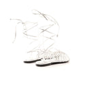 Silver strappy sandals on a white background