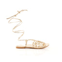 Gold strappy sandal on a white background