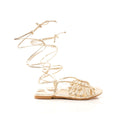 Gold strappy sandal on a white background