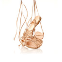 Rose gold high-heeled shoe with intricate design on a white background