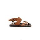 Brown sandals with black soles on a white background
